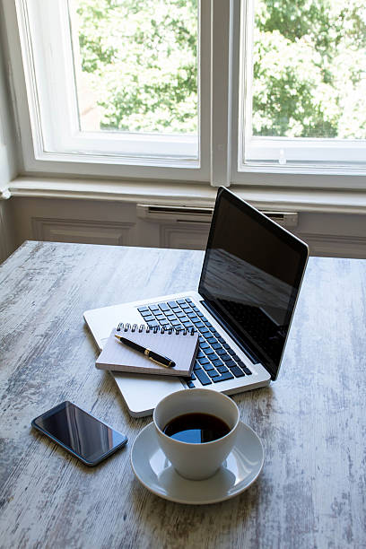 istock Working with a cup of coffee close to the window 521619787