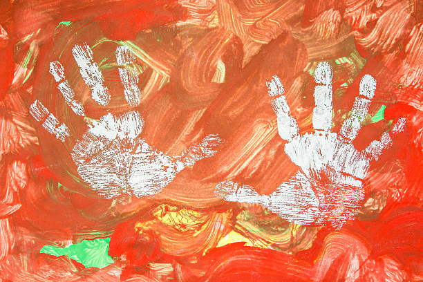 istock Child drawing painting with his white hands on colorful background 521619880