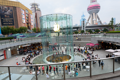 Shanghai, Сhina - August 30, 2015: People queued for iPhone 6s and iPhone 6s Plus at the Apple's flagship store in Lujiazui, Shanghai  China. Oriental Pearl Tower in the background. 