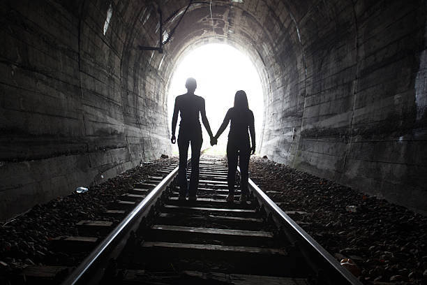 istock Couple walking together through a railway tunnel 521620946