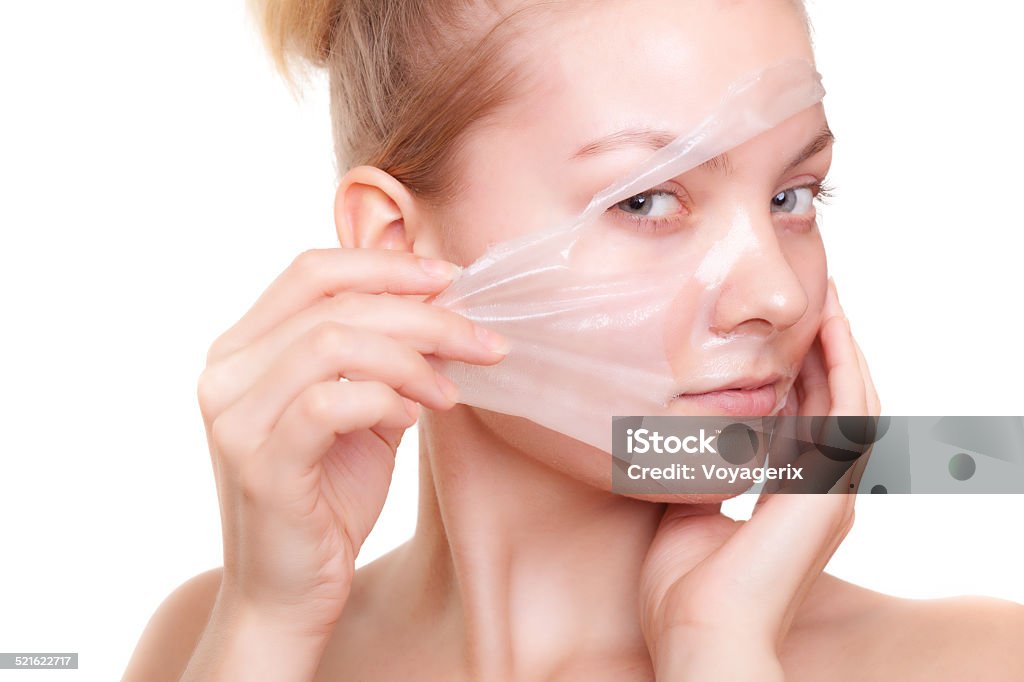 Girl woman in facial peel off mask. Skin care. Portrait of girl young woman in facial peel off mask isolated on white. Peeling. Beauty and body skin care. Studio shot. Adult Stock Photo