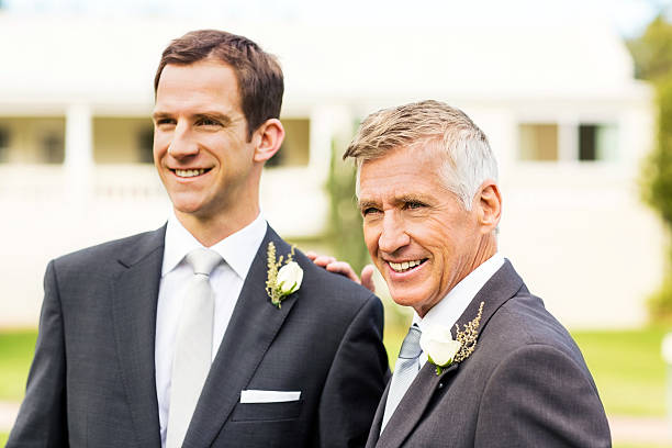 istock Groom And Father Looking Away In Garden 521622823