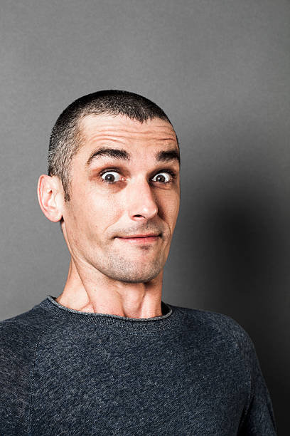 istock surprised man with eyes wide open holding his breath 521623412