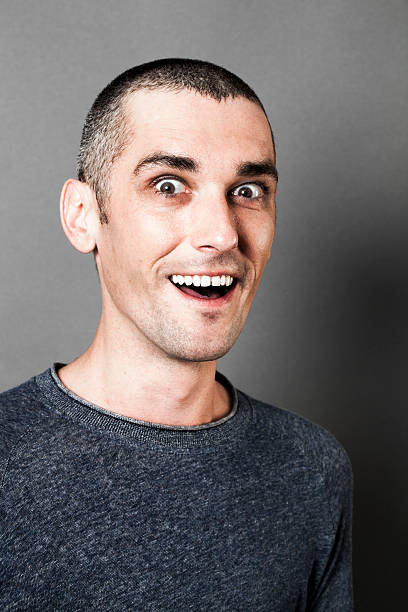 istock surprise concept for thrilled man with dark circles laughing 521623574