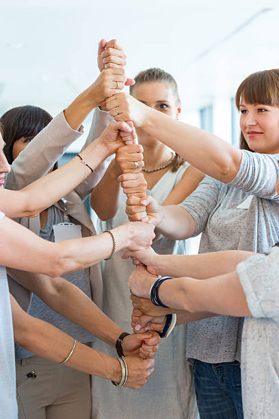 istock Group of women building tower with palms 521623581