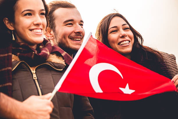 happy friends during a demonstration - türk bayrağı stok fotoğraflar ve resimler