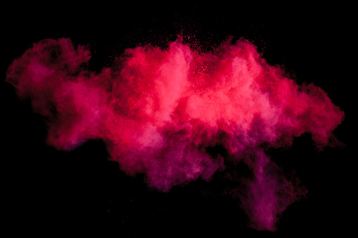 Freeze motion of red dust explosion isolated on black background