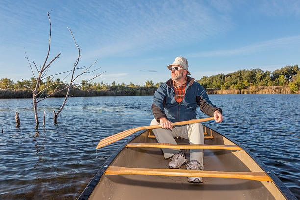 istock paddling canoe on a lake 521624127