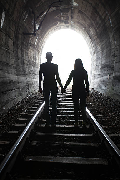 istock Couple walking together through a railway tunnel 521624428