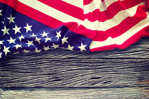 istock American flag on wooden background 521624778
