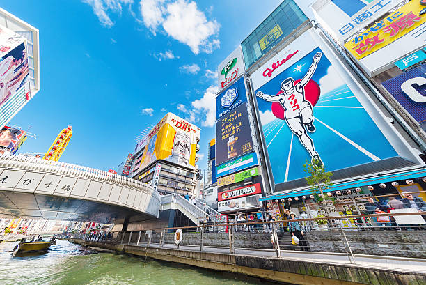Osaka city, Japan Osaka, Japan - April 14, 2016: The famed advertisements of Dotonbori shine at night. With a history reaching back to 1612, the district is now one of Osaka's primary tourist destinations.  osaka prefecture photos stock pictures, royalty-free photos & images