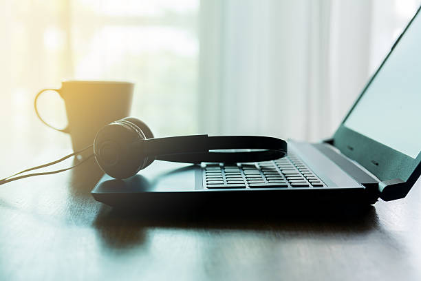 istock laptop headphone and coffee cup silhouette 521625710