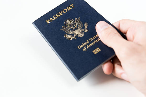 istock aperson holding a new U.S passport 521652345