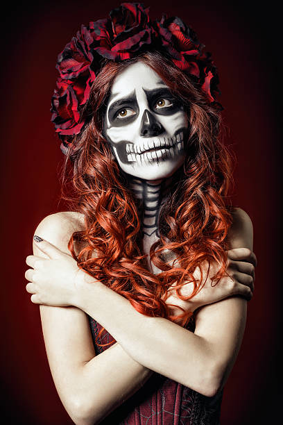 istock Sad young woman with muertos makeup (sugar skull) 521652939