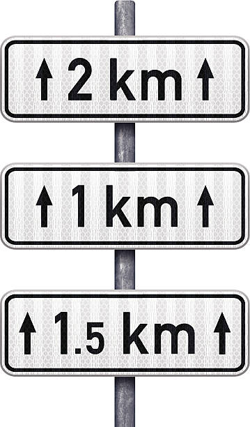 White traffic signs indicating distance ahead (metric) Three informative road signs with 2, 1 and 1.5 kilometers text and two arrows. White retroreflective rectangular signs with thin black line and black text indicating distances in metric measurements. All signs are attached to a pipe steel post. Photorealistic vector illustration. Layered EPS10 file with transparencies and global colors. Individual elements and textures. Related images linked below. kilometre stock illustrations