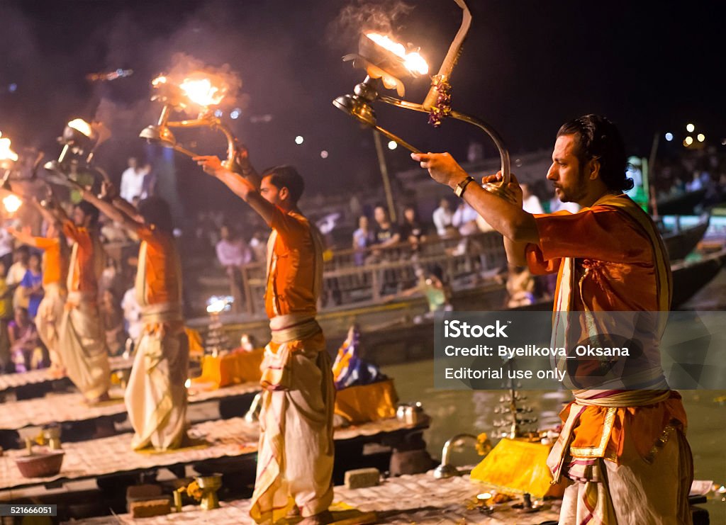 Hindu priest performs the Ganga Aarti religious  ritual  Varanasi, India - September 30, 2013:  A Hindu priest performs the Ganga Aarti  ritual  on the banks of the river Ganges. Aarti - Praying Stock Photo