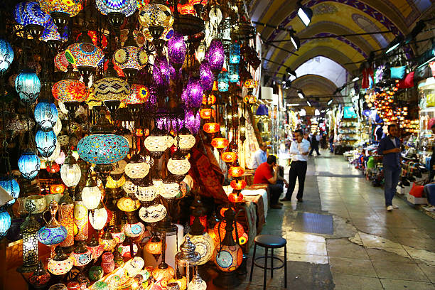 Light store in Grand Bazaar of Istanbul, Turkey Istanbul, Turkey - October 21, 2014: a store in Grand bazaar, selling typical multicolored turkish lights. Some people are visible in the image. grand bazaar istanbul stock pictures, royalty-free photos & images