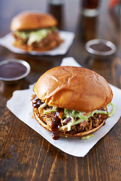 istock barbecue pulled pork sandwiches with cole slaw on wood table 521666669