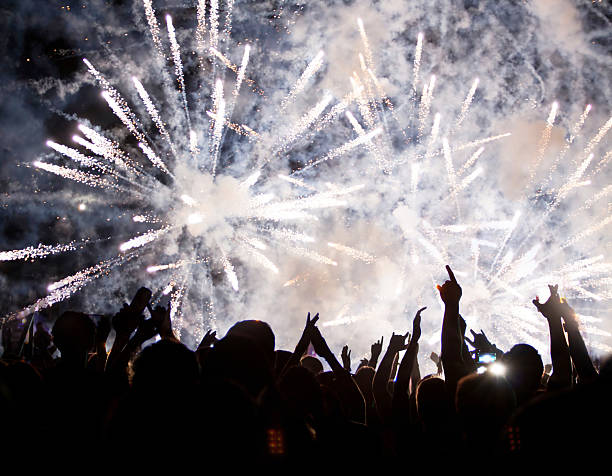 istock Crowd celebrating the New Year with fireworks 521669399