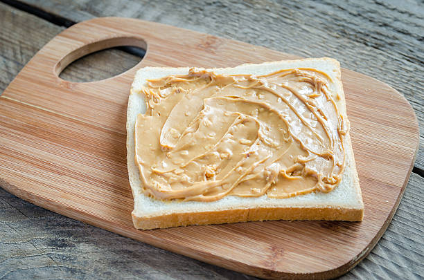 istock Sandwich with peanut butter on the wooden board 521680883