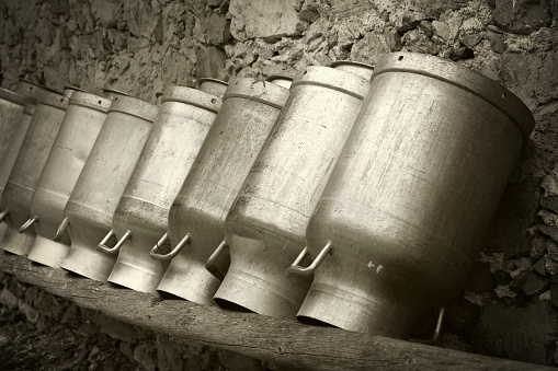 Old milk cans, Tyrol, Austria. Tinted image, vintage style