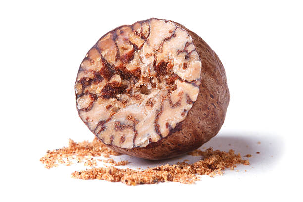 istock half a nutmeg and ground isolated on white background 521682083