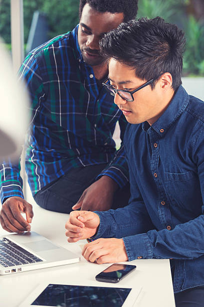 istock African American and Asian men working on a computer 521683547