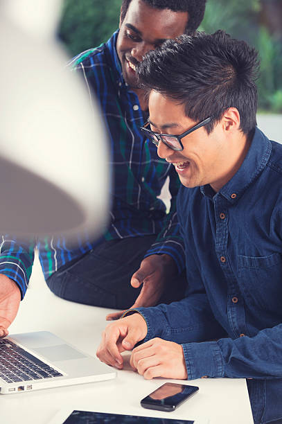 istock African American and Asian men working on a computer 521683567