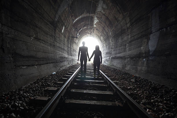istock Couple walking together through a railway tunnel 521685938