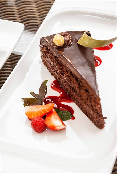istock Chocolate Cake with Icing, Raspberries, and Sauce 521686313