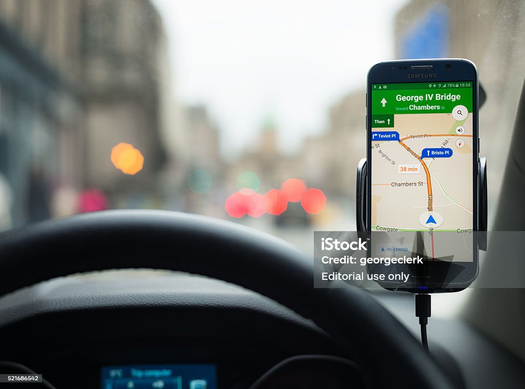 Google Maps Navigation on a Samsung S6 smartphone Edinburgh, UK - April 14, 2016: A Samsung S6 smartphone being used in a car, running Google's Maps navigation software for driving directions. Global Positioning System Stock Photo