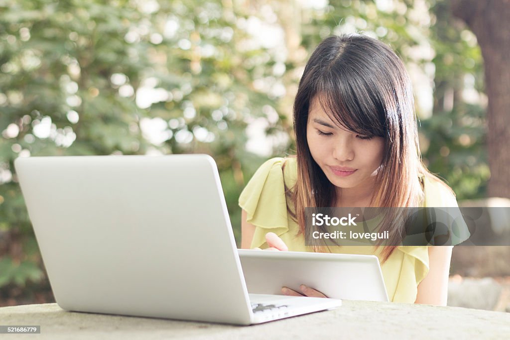 portrait of asian female student with laptop in campus Adult Stock Photo