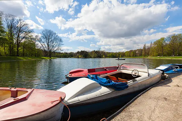 A picturesque lake (Kalscheurer Weiher) with vintage pedal boat in the town forest (Stadtwald) of Cologne, Germany