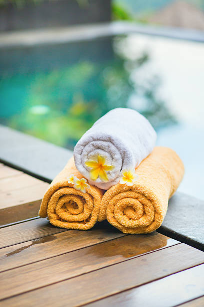 istock Towels with white frangipani flowers in spa 521687789