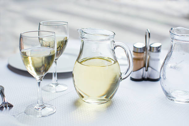 istock Jug of white wine with two glasses 521687803
