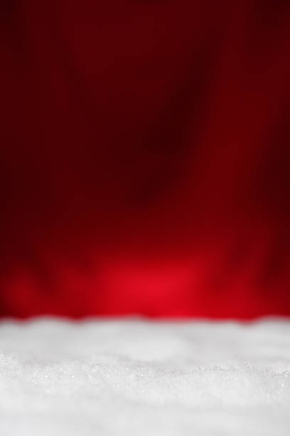 istock Christmas snow against red background with copy space 521687931