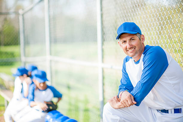 istock Coach with His Team in the Dug Out 521688120