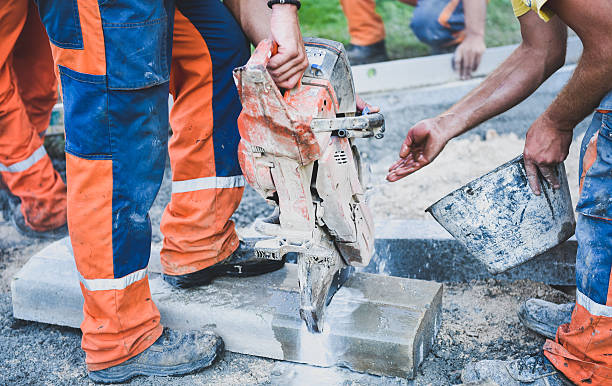 istock Construction worker cutting concrete paving stabs or metal for s 521688404