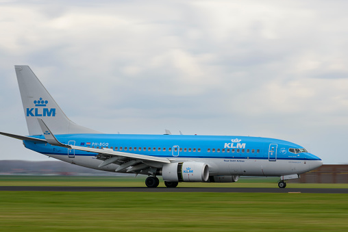 Schiphol, The Netherlands - April 8, 2016: KLM Airlines Boeing 737-7K2 at the runway at Schiphol airport near Amsterdam in The Netherlands. Panning image with motion blur.