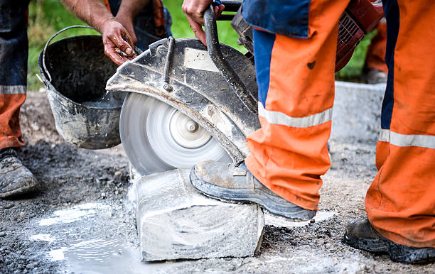 istock Construction worker cutting concrete paving stabs or metal for s 521688502
