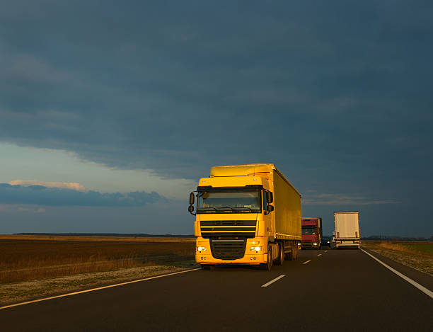 istock Yellow truck on the road at sunset 521688890
