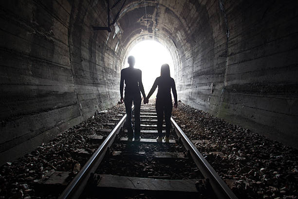 istock Couple walking together through a railway tunnel 521689178