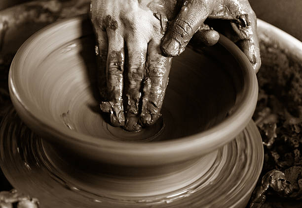 istock potter's hands with the product on a potter's wheel 521690060