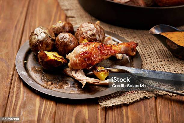 Barbecued Chicken Leg With Baked Potatoes Stock Photo - Download Image Now - Animal Body Part, Animal Leg, Animal Limb