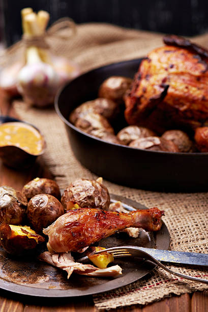 istock Barbecued chicken leg with baked potatoes 521690616