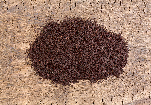 istock Kona coffee ground beans on an old board 521690690