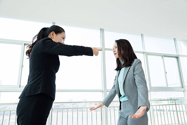 istock Two businesswomen arguing in office 521691224