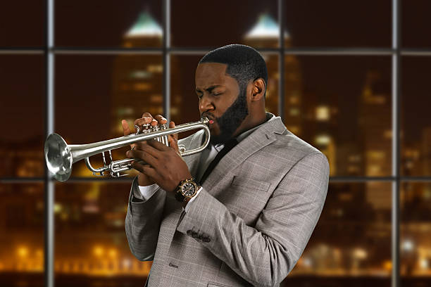 istock Black man plays the trumpet. 521691478