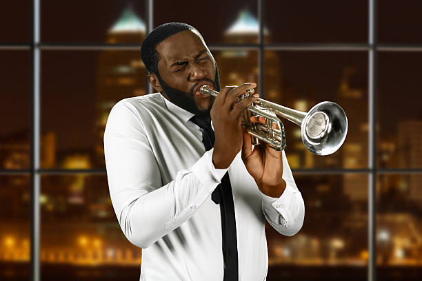 istock Man in shirt playing trumpet. 521691644