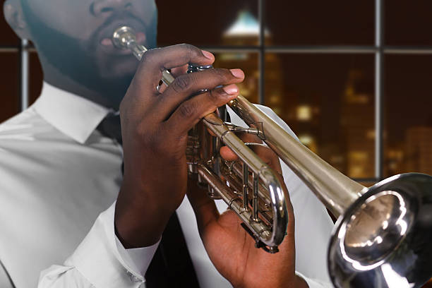 istock Afro man's hand on trumpet. 521691698